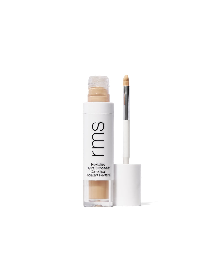 Open RMS Beauty Revitalize Hydra Concealer with doe-foot applicator showing light beige creamy makeup product in clear and white recyclable packaging