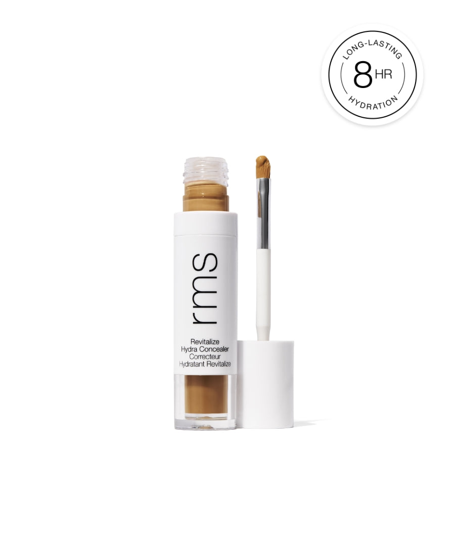 Open tube of Revitalize Hydra Concealer with applicator wand showing medium tan shade, highlighting long-lasting 8 hour hydration formula in white packaging.