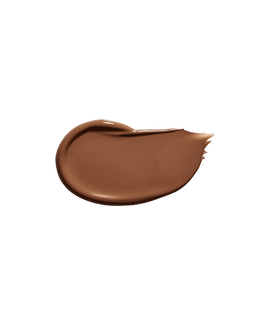 Smooth swatch of medium to deep beige creamy makeup product showcasing the rich texture of Revitalize Hydra Concealer, highlighting clean beauty and natural ingredients.