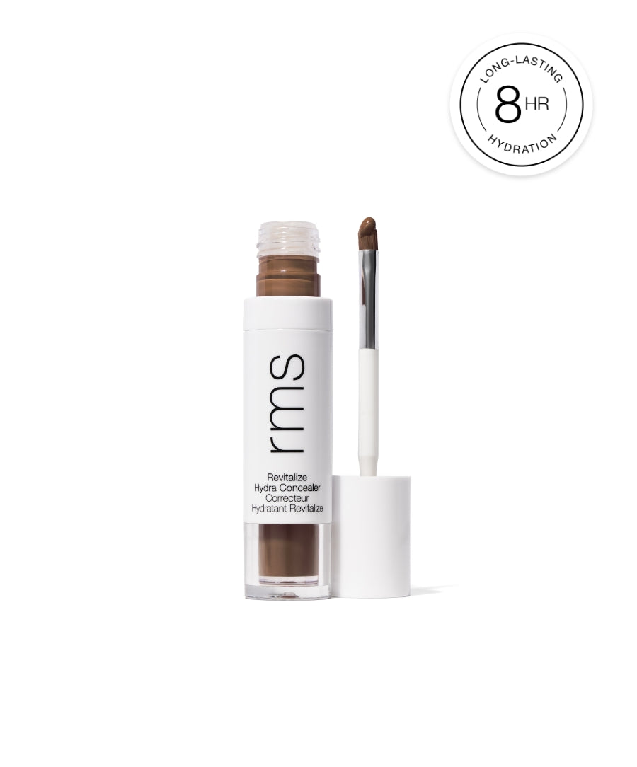 Open tube of Revitalize Hydra Concealer with applicator displaying creamy medium brown shade, alongside a label indicating 8 hours of long-lasting hydration.