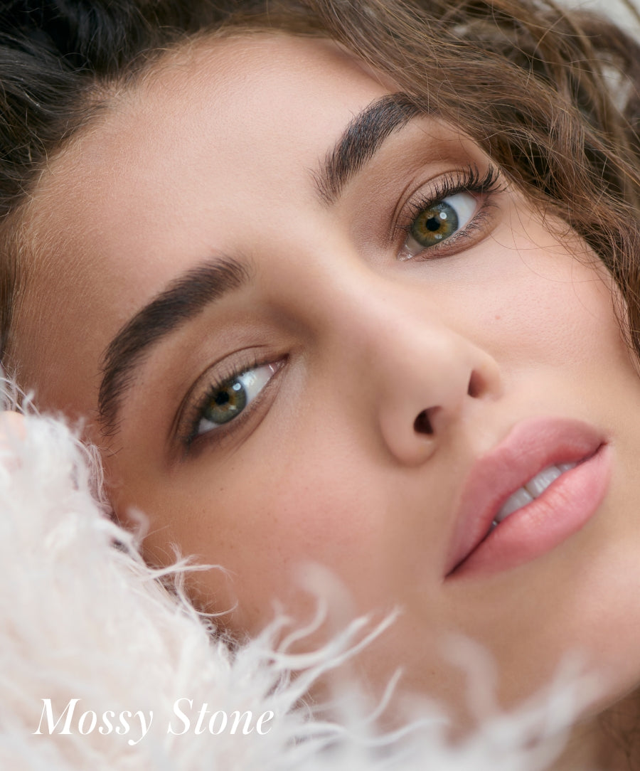 Close-up of a woman with green eyes wearing Cashmere Matte Eyelights makeup in a natural mossy stone shade, featuring clean beauty and natural ingredients.