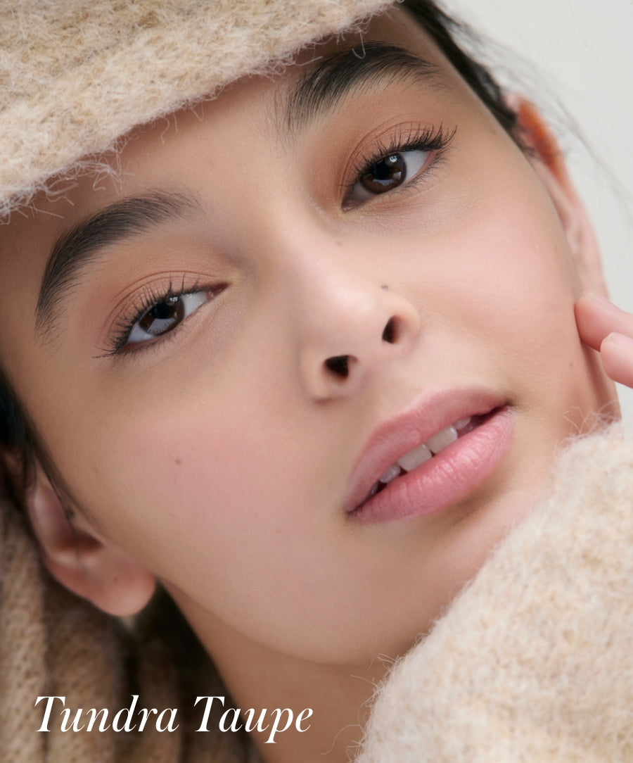 Close-up of a woman wearing soft, natural makeup featuring Cashmere Matte Eyelights in a warm taupe shade, highlighting clean beauty and smooth, matte finish.