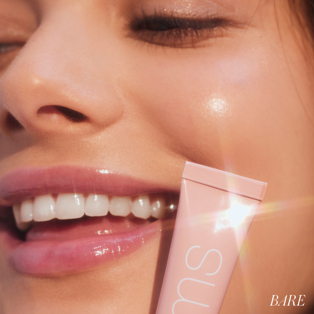 Close-up of a smiling woman with glossy lips wearing Liplights Cream Lip Gloss, highlighting clean beauty and natural ingredients for a radiant, sustainable makeup look.