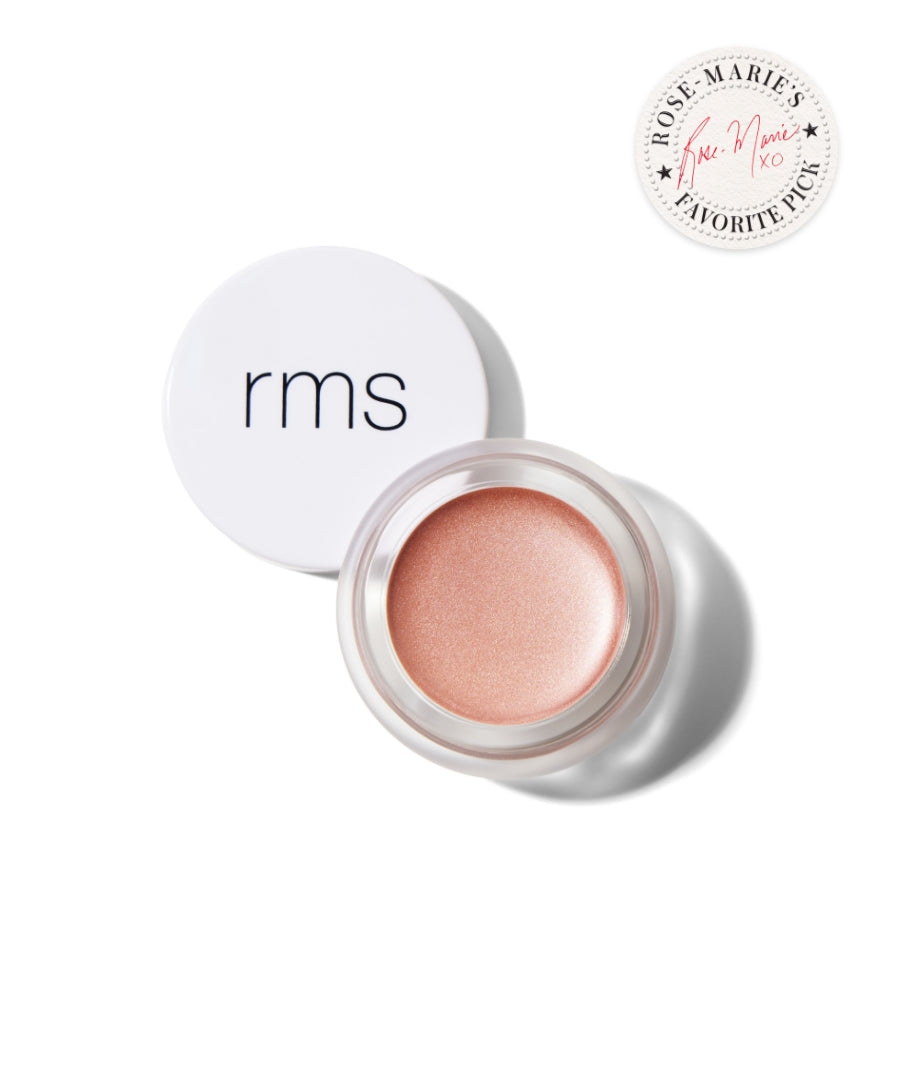 Open jar of luminous rose gold cream highlighter with white lid featuring rms logo, showcasing Luminizer in a clean beauty, sustainable packaging style.