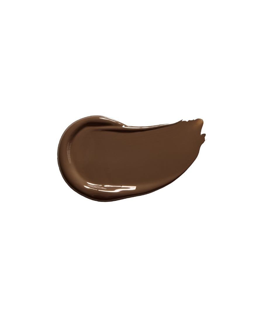 Smooth, creamy swatch of Revitalize Hydra Concealer in a deep, rich natural brown shade highlighting clean beauty and skincare infused makeup qualities.