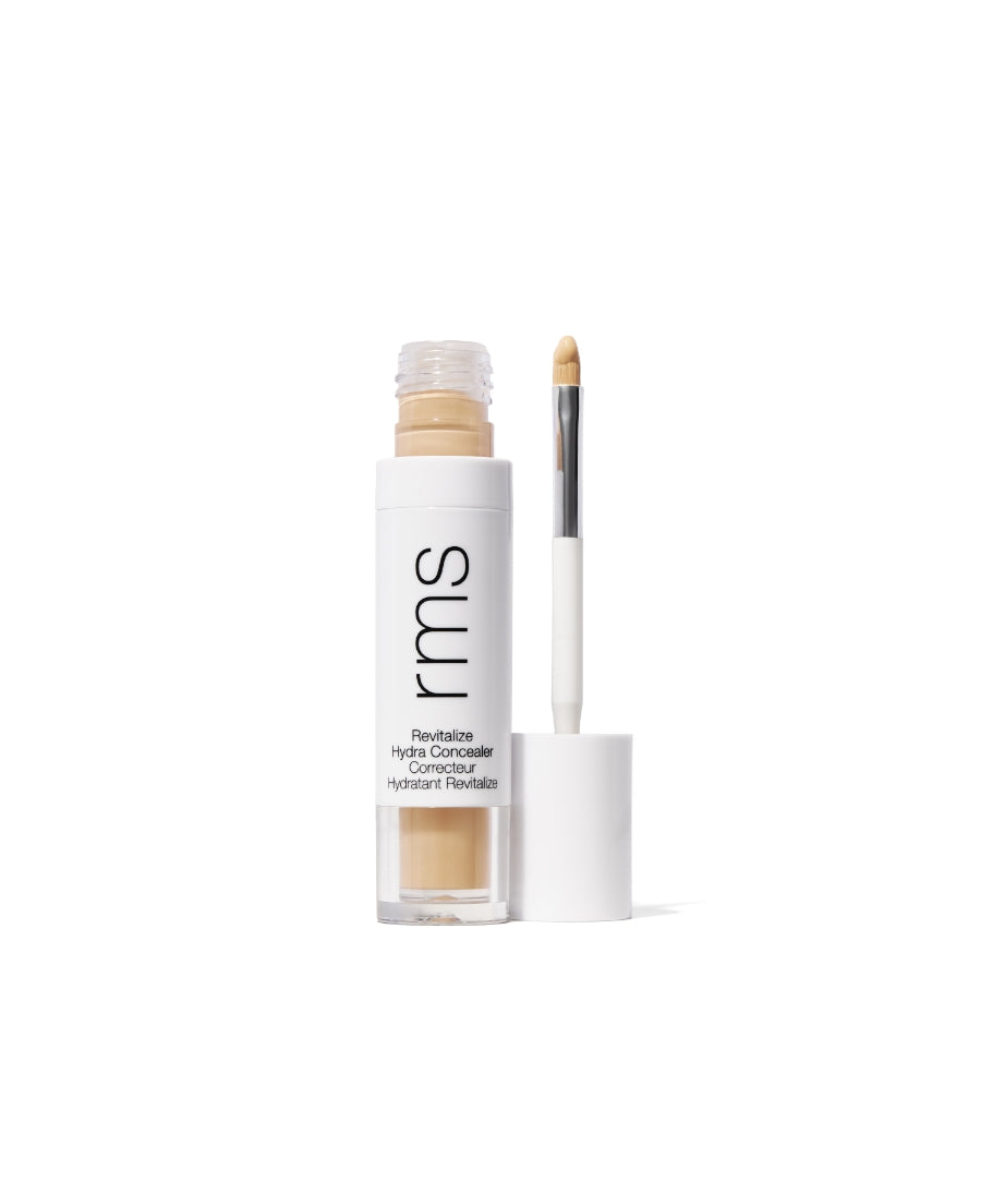 Revitalize Hydra Concealer with natural beige tone, featuring a sleek white tube and applicator brush, designed for clean beauty and skincare-infused makeup.