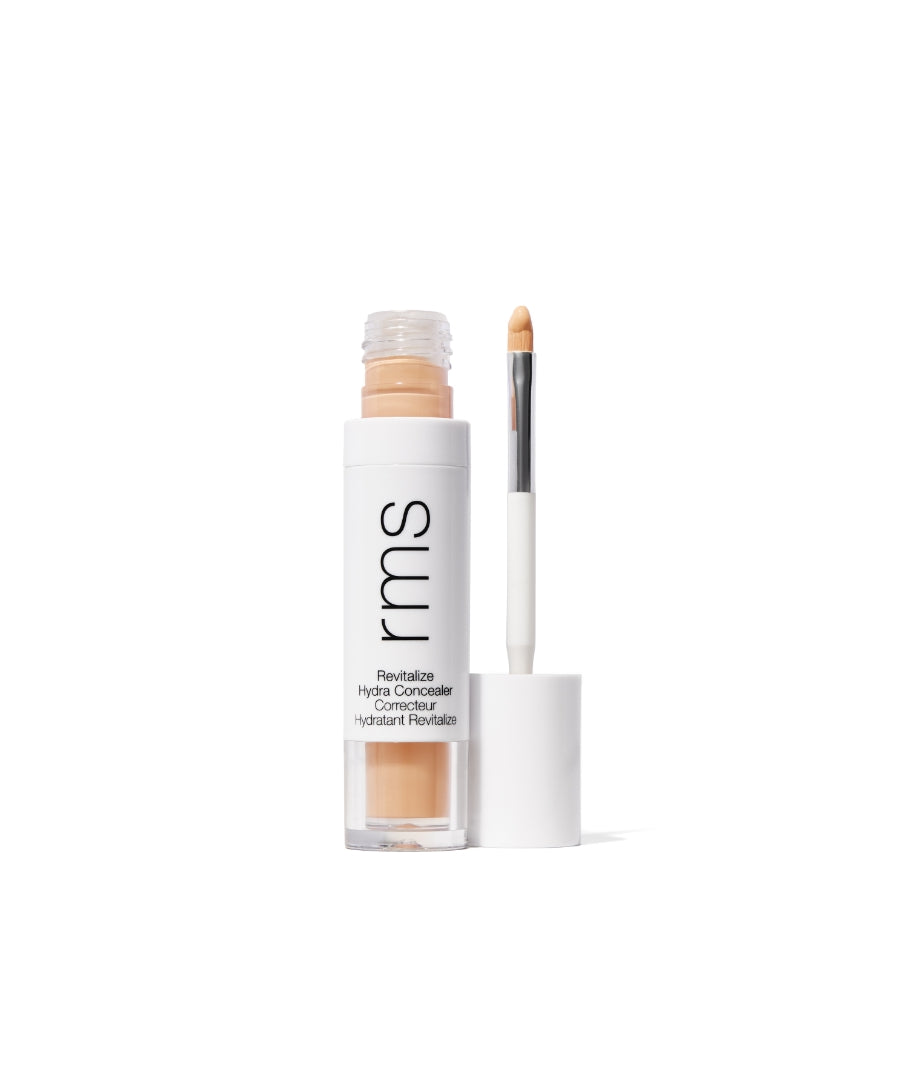 Revitalize Hydra Concealer in a clear tube with white cap and built-in applicator brush, featuring natural beige creamy formula for clean beauty and skincare infused makeup.