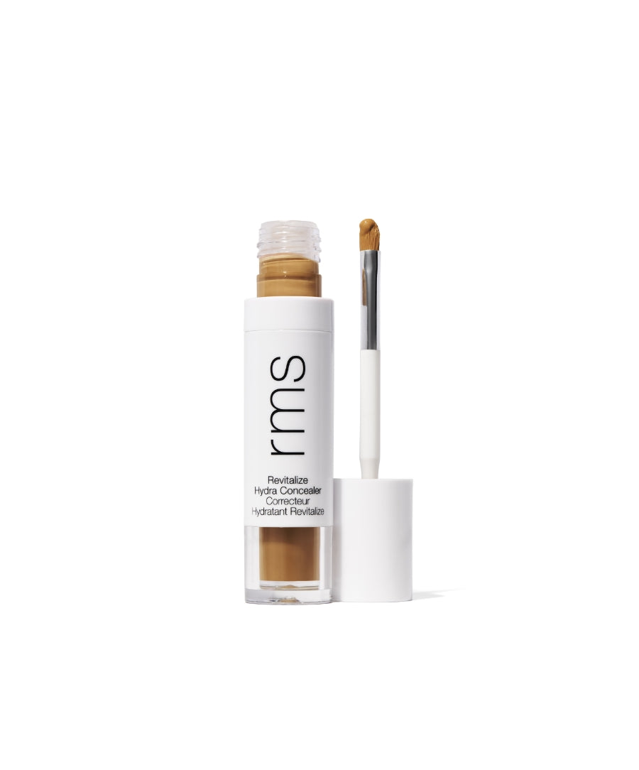 Revitalize Hydra Concealer with a beige creamy formula in a clear tube featuring a white cap and applicator brush for precise, clean beauty makeup application.
