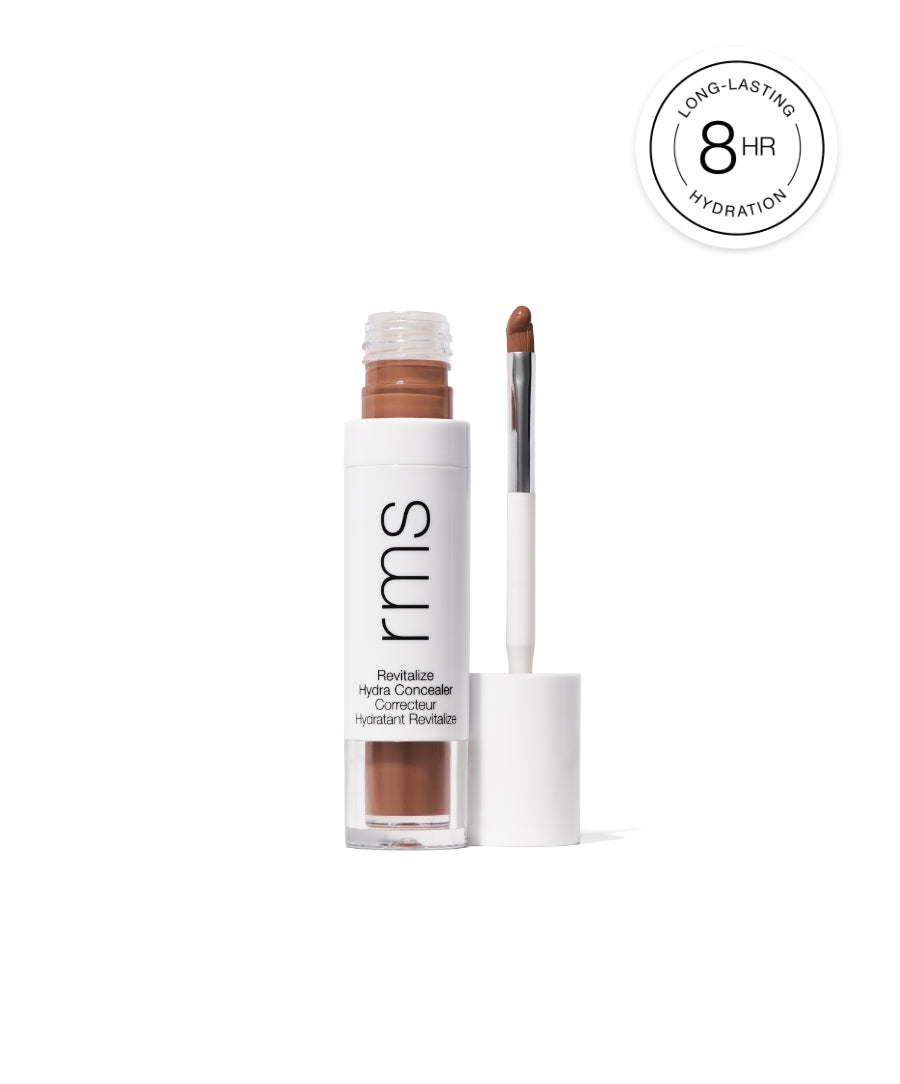 Open tube of Revitalize Hydra Concealer showing medium brown shade with an applicator wand next to it and a label highlighting 8-hour long-lasting hydration