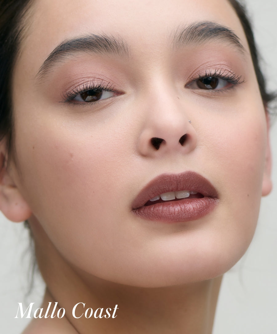 Close-up of a woman wearing Cashmere Matte Eyelights eyeshadow in a soft, natural tone with clean beauty, cruelty free makeup, and sustainable packaging qualities.
