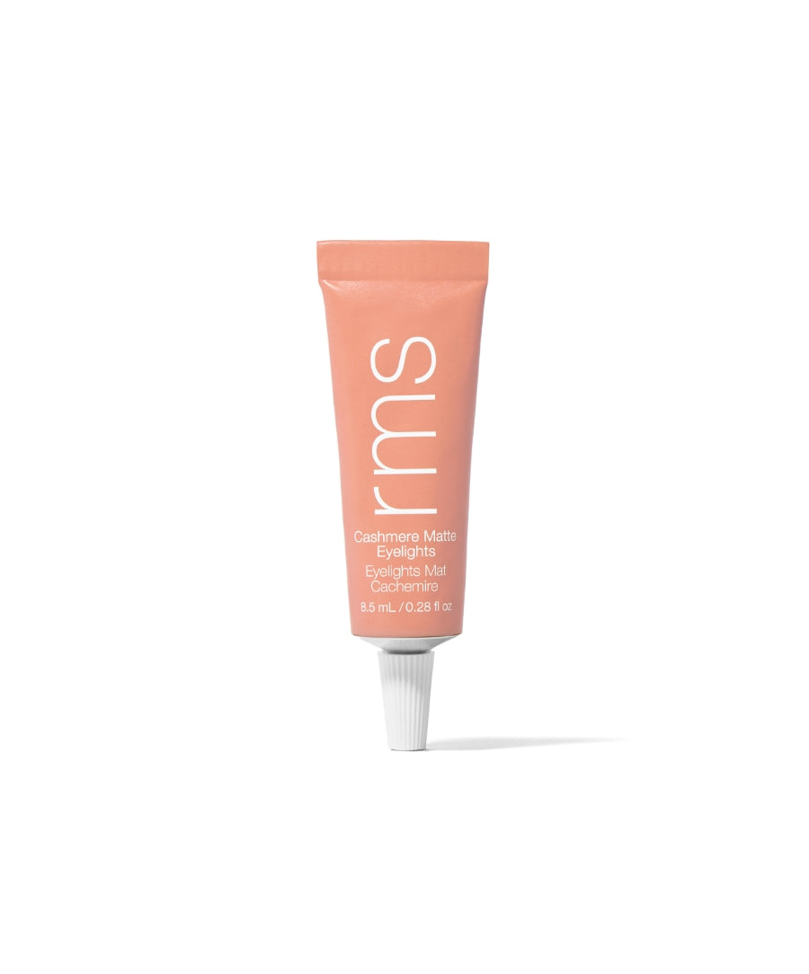 Tube of Cashmere Matte Eyelights in soft peachy shade with clean beauty formulation, highlighting natural ingredients and cruelty free makeup by RMS Beauty.