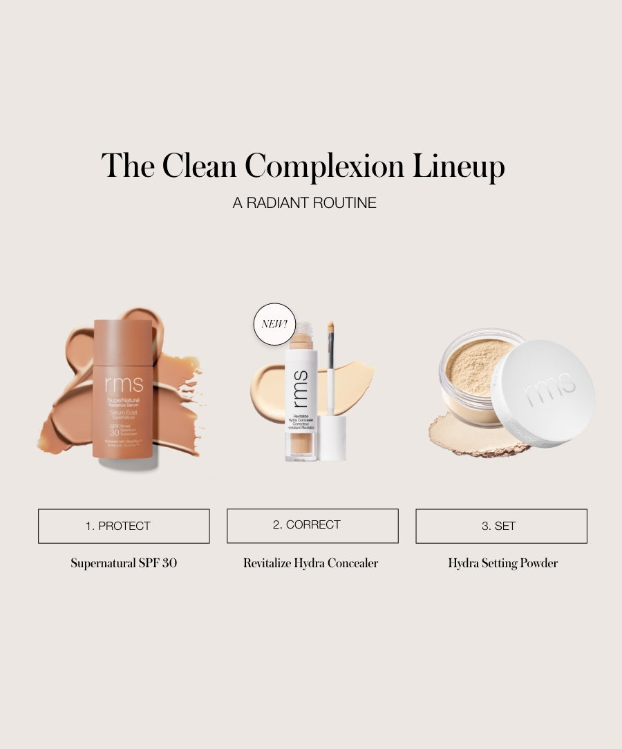 Revitalize Hydra Concealer tube with applicator shown between tinted moisturizer and loose setting powder, representing a clean beauty complexion routine.