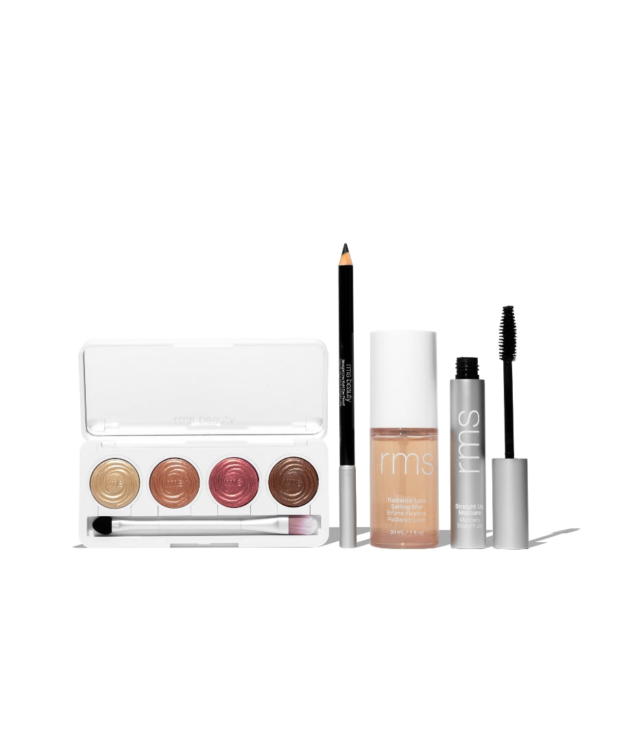 The Signature Artistry Set featuring a palette with four warm cream eyeshadows, a black eyeliner pencil, a radiant foundation, and a volumizing mascara in sleek packaging.