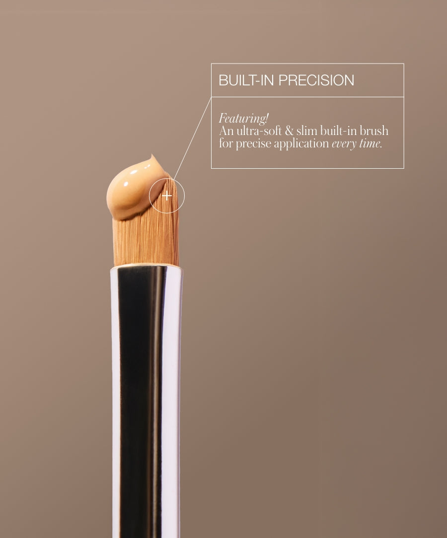 Close-up of a slim brush tip with a dollop of Revitalize Hydra Concealer cream, highlighting the built-in precision for smooth and precise application every time.
