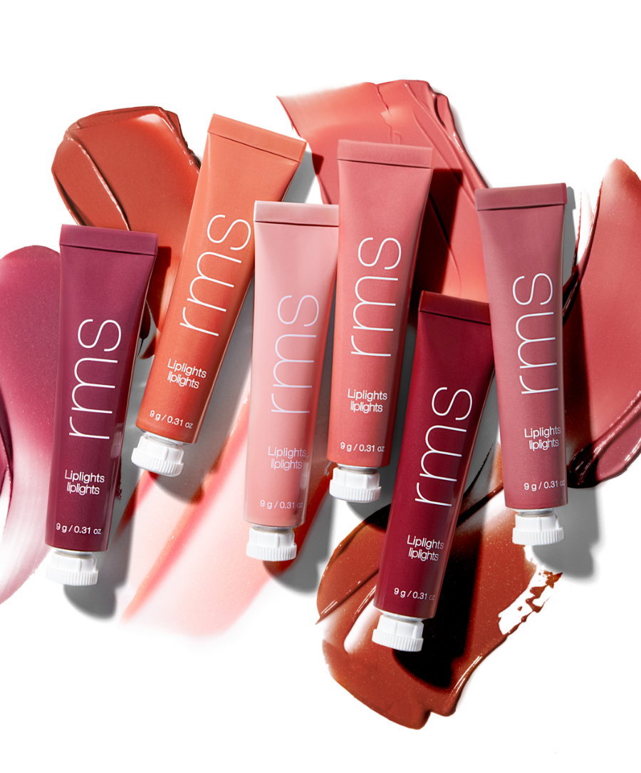 Six tubes of Liplights Cream Lip Gloss in varying shades of pink, coral, and red arranged over matching swatches showcasing creamy, glossy textures with clean, natural ingredients by RMS Beauty.
